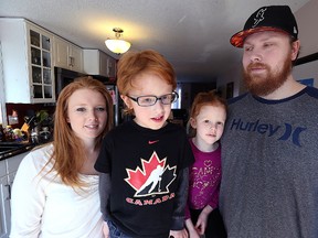 Davin Bazylewski (second from left), 6, with his mother Kerri, sister Lacey, 5, and father Ryan (from left) in Winnipeg on Sun., March 5, 2017. His family is trying to raise funds to buy a special pair of glasses to assist his eyesight. Kevin King/Winnipeg Sun/Postmedia Network