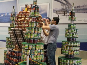 Members of the Arlanxeo Rubbernecks team tweak their rotating dancing beaver creation at the Lambton Mall during the start of Canstruction this weekend. Their creation took top prize Sunday in the structural ingenuity category. Barbara Simpson/Sarnia Observer/Postmedia Network