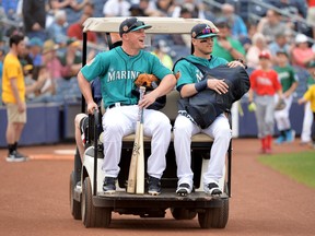 Kyle Seager, left, and Shawn O'Malley of the Seattle Mariners ride to the field on a golf cart prior to a spring training game against the Oakland Athletics at Peoria Stadium on March 5, 2017 in Peoria, AZ. (Jennifer Stewart/Getty Images)