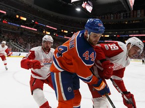 Edmonton Oilers forward Zack Kassian battles along the boards with Detroit Red Wings Anthony Mantha (39) and Frans Nielsen (51) at Rogers Place in Edmonton on Saturday, March 4, 2017. (Ian Kucerak)