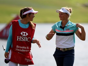 Brooke Henderson, right, chats with her sister and caddy, Brittany Henderson, during Sunday's final round.