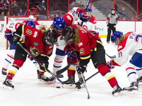 Players from Les Canadiennes de Montreal and the Calgary Inferno battle for the puck during the Clarkson Cup on Sunday at the Canadian Tire Centre. (Ashley Fraser/Postmedia Network)