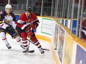 Ottawa 67's defenceman Peter Stratis battles for the puck against Barrie Colts' Kirill Nizhnikov at TD Place Arena in Ottawa on Sunday, March 5, 2017. (Ashley Fraser/Postmedia)