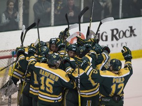 The University of Alberta Golden Bears celebrate a win over the University of Calgary Dinos in the Canada West semifinal round at Clare Drake Arena on Feb. 25. They went on to capture the conference title on the weekend in Saskatoon. (Gred Southam)