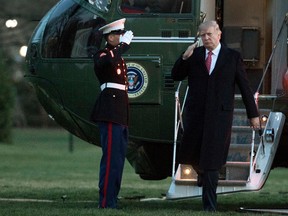 U.S. President Donald Trump salutes as he disembarks Marine One upon arrival at the White House in Washington, Sunday, March 5, 2017. (AP Photo/Manuel Balce Ceneta)
