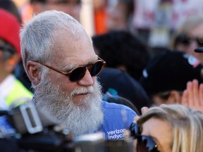 In this Sept. 18, 2016, file photo, David Letterman stands near victory lane and watches celebrations after the IndyCar auto race in Sonoma, Calif. Letterman tells Vulture in an interview published online on March 5, 2017, that says he would have handled President Donald Trump a bit differently than “Tonight Show” host Jimmy Fallon. (AP Photo/Eric Risberg, File)