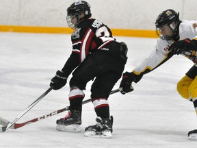 Defenceman Jason Mills (6) of the Mitchell Pee Wees uses his long reach to thwart this South Huron opponent from breaking into the clear during action from Game 5 of their OMHA ‘CC’ semi-final series Saturday, March 4. The visiting Sabres doubled their hosts 4-2 to win the series in five games. ANDY BADER/MITCHELL ADVOCATE