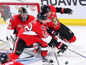 Ottawa Senators goalie Craig Anderson (41) gets a little help from defenceman Dion Phaneuf (2) and centre Chris Kelly (22) during third period NHL hockey action in Ottawa on Saturday, March 4, 2017. (THE CANADIAN PRESS/Sean Kilpatrick)