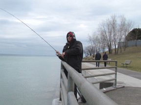 Sarnia's Brian Johnson fishes Monday not far from where Lake Huron meets the St. Clair River. Politicians and others in the region are worried about the possibility of deep funding cuts to the U.S. Great Lakes Restoration Initiative. (Paul Morden/Sarnia Observer)