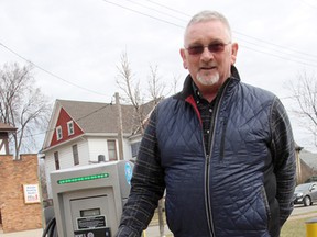 Peter Hungerford stands by the city's electric vehicle charging station at the Charlotte Street parking lot Monday. The station is operational, but an official opening is planned sometime next week. (Tyler Kula/Sarnia Observer/Postmedia Network)