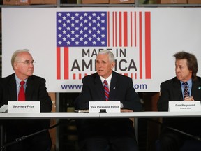 U.S. Vice President Mike Pence (centre), with Health and Human Services Secretary Tom Price (left), and Frame USA CEO Dan Regenold, speaks during a listening session with local business owners at the Frame USA facility in Springdale, Ohio, on March 2, 2017. (AP Photo/John Minchillo)