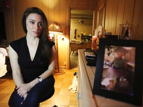 In this Feb. 13, 2017 photo, Casey Anthony poses for a portrait next to a photo of her daughter, Caylee, in her West Palm Beach, Fla., bedroom. In an exclusive interview with The Associated Press, Anthony claims the last time she saw Caylee she “believed that she was alive and that she was going to be OK.” (AP Photo/Joshua Replogle)