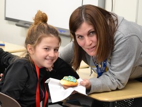 St. David School educational assistant Brenda Jack shares a cupcake with Grade 5/6 student Katelynn Michauville. Supplied photo
