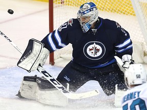 San Jose Sharks centre Chris Tierney fires a shot wide of Winnipeg Jets goaltender Connor Hellebuyck in Winnipeg on Mon., March 6, 2017. Kevin King/Winnipeg Sun/Postmedia Network