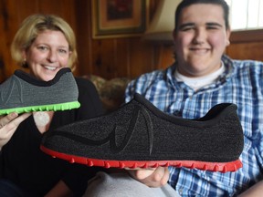 In a Wednesday, March 1, 2017 photo, Broc Brown, right, shows off his new shoes with Feetz CEO Lucy Beard at his grandmother’s home in Michigan Center, Mich. (J. Scott Park/Jackson Citizen Patriot via AP)