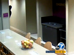 A masked man looks around the corner of a wall at the Home 2 Suites hotel in Omaha, Neb. before he allegedly attacked a female hotel employee. (Screengrab)