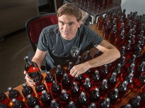 North of 7's Greg Lipin with all 244 bottles of the new Leatherback extra-strength barrel-aged rum. WAYNE CUDDINGTON / OTTAWA CITIZEN