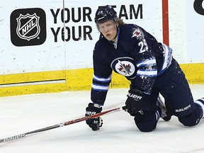 Winnipeg Jets forward Patrik Laine reacts after taking a hard spill into the boards late in NHL action against the San Jose Sharks in Winnipeg on Mon., March 6, 2017. Laine's ill-advised pass attempt at his own blue line in the third period against San Jose, produced the shorthanded goal that broke a 1-1 tie in a 3-2 Sharks win. Kevin King/Winnipeg Sun/Postmedia Network