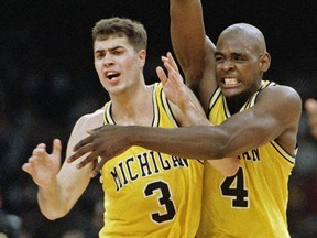 In this April 3, 1993 file photo, Michigan's Chris Webber and Rob Pelinka celebrate in New Orleans as they defeated Kentucky 81-78 in overtime to advance to the NCAA college basketball championship game against North Carolina. (AP Photo/Ed Reinke, File)