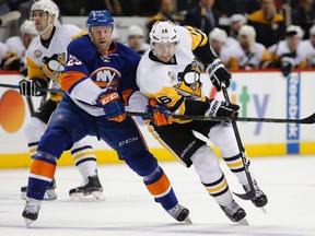 New York Islanders left-winger Jason Chimera defends against Pittsburgh Penguins center Eric Fehr on Nov. 30, 2016, in New York. (The Canadian Press)