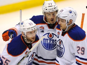 Edmonton Oilers' Oscar Klefbom (77) and Leon Draisaitl (29) congratulate Mark Letestu (55) after his goal against the St. Louis Blues on Feb. 28, 2017, in St. Louis. (AP Photo)