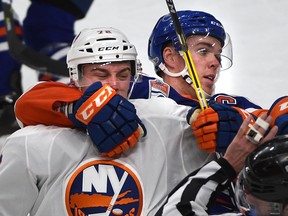 Edmonton Oilers captain Connor McDavid grabs New York Islanders' Anthony Beauvillier after a face-off at Rogers Place in Edmonton on Wednesday, March 7, 2017. (Ed Kaiser)