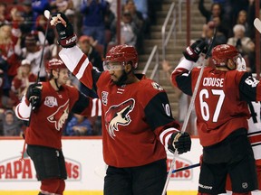 Coyotes winger Anthony Duclair (10) celebrates his assist on a goal by teammate Peter Holland during the second period of an NHL game against the Hurricanes in Glendale, Ariz., on Sunday, March 5, 2017, (AP Photo/Ralph Freso)