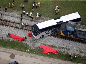 Responders work the scene where a train hit a bus in Biloxi, Miss., Tuesday, March 7, 2017. (AP Photo/Gerald Herbert)