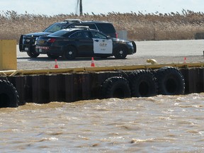 OPP vehicles sit at a spot on the east side of the Port Stanley pier on Wednesday March 8, 2017 where there are reports that a vehicle went into the water Tuesday night. (MORRIS LAMONT, The London Free Press)