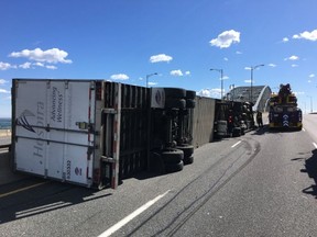 A tractor trailer is flipped on its side on the Burlington Skyway on Wednesday, March 8, 2017. (@OPP_HSD)