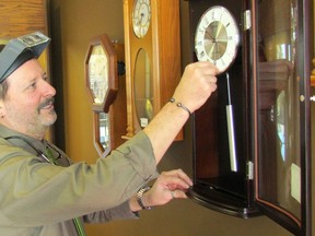 Markus Henne, owner of Henne's Jewellery, changes the time on a clock in the Sarnia store's showroom. Daylight Saving Time arrives Sunday, and public health officials are encouraging drivers to watch for signs of fatigue, in the days that follow. (Paul Morden/Sarnia Observer)