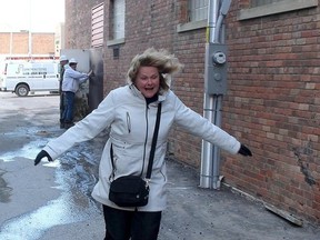 Diane Thiesen is pushed along by powerful winds as they went whipping between two buildings on Llyewellen Street in Chatham, Ont. on Wednesday March 8, 2017. Environment Canada had forecasted that winds could reach up to 100 kilometers-per-hour. (Ellwood Shreve/Chatham Daily News)