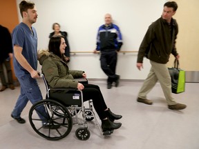 "Patient" and Providence Care staff member Brittany MacComish and porter Devan Bruce make their way into one of the new rooms at the Providence Care Hospital during a mock move-in on Tuesday. (Ian MacAlpine/The Whig-Standard)