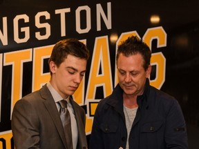 Nathan Dunkley, the Kingston Frontenacs' first-round draft choice, signs his contract with General Manager Doug Gilmour last May. (Nick Tardif/For the Whig-Standard)