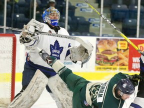London Nationals goalie Cameron Zanussi clears his own crease knocking Kenny Chisholm of the St. Marys Lincolns to the ice during the first period of their 5th playoff game at the Western Fair Sports Centre in London, Ont. on Wednesday March 8, 2017. Although the Lincolns had a 5-3 powerplay and more chances the score was 4-0 at the first intermission. Mike Hensen/The London Free Press/Postmedia Network