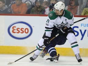 Dallas Stars forward Patrick Sharp gets tangled up with a Winnipeg Jets player on Feb. 14, 2017. (Kevin King/Winnipeg Sun/Postmedia Network)