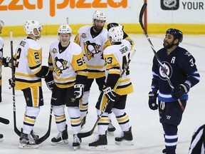 Mark Streit, Chad Ruhwedel, Jake Guentzel, Nick Bonino and Conor Sheary (from left) of the Penguins celebrate a goal as Jets defenceman Dustin Byfuglien skates by. The Jets lost 7-4. (Kevin King/Winnipeg Sun)