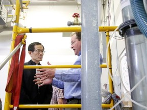 Dr. Dean Millar, professor of Energy in Mining at Laurentian's Bharti School of Engineering, and Energy Director of Laurentian's MIRARCO explains how a unique hydraulic air compressor (HAC) system may be developed to clean and cool the air in ultra-deep mining environments, where air temperatures may reach upwards of 40 degrees Celsius to Dr. Rui Wang, Laurentian University Vice President of Research, at the lab at Cambrian College in Sudbury, Ont. on Wednesday March 8, 2017. Gino Donato/Sudbury Star/Postmedia Network