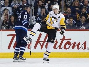 Malkin celebrates a goal against the Jets, as Laine looks on Wednesday, March 8, 2017.