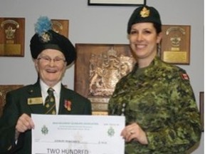Marjorie Thibeault, left, president of the Irish Regiment Association of Sudbury, and Captain Tammy Valtonen, Commanding Officer of 2912 Sudbury Irish Army Cadets, take part in a donation. Supplied photo