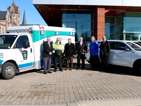 David Mayberry, Mike Maycock, Mark Shulman, Ben Addley, Melissa Abercrombie and Peter Crockett (from left to right) stand with Oxford County's new environmentally friendly vehicles in front of the Oxford County administration building on Wednesday. (BRUCE CHESSELL/Sentinel-Review)