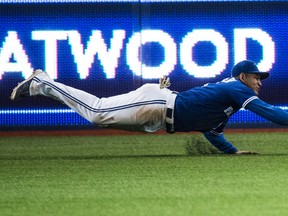 Toronto Blue Jays Ezequiel Carrera makes a diving catch against the Oakland A's at Rogers Centre in Toronto on April 23, 2016. (Craig Robertson/Toronto Sun)