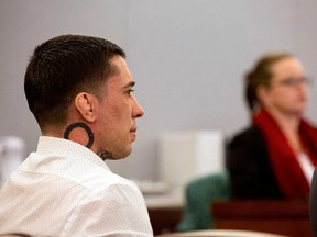 Former mixed martial arts fighter War Machine, also known as Jonathan Koppenhaver, listens to the testimony from victim and ex-girlfriend Christine Mackinday during his trial at the Regional Justice Center, Wednesday, March 8, 2017, in Las Vegas. (Elizabeth Brumley/Las Vegas Review-Journal via AP)