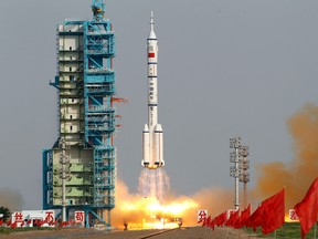 In this June 16, 2012, file photo, the Shenzhou 9 spacecraft rocket launches from the Jiuquan Satellite Launch Center in Jiuquan, China. State media say China is developing an advanced new spaceship capable of both flying in low-Earth orbit and landing on the moon. The newspaper Science and Technology Daily cited spaceship engineer Zhang Bainian as saying the new craft would be recoverable and have room for multiple astronauts. (AP Photo/Ng Han Guan, File)