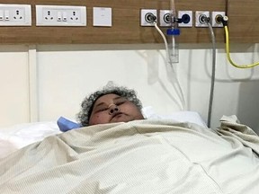 This handout photograph released by The Saifee Hospital on March 9, 2017, shows Egyptian patient Eman Ahmed Abd El Aty as she lies in a hospital bed at The Saifee Hospital in Mumbai on February 11, 2017, ahead of an operation. Indian doctors said March 9, 2017, that an Egyptian believed to be the world's heaviest woman had successfully undergone weight-loss surgery after losing over 100 kilogrammes (220 pounds). Eman Ahmed Abd El Aty, who previously weighed around 500 kgs, had not left her house in Egypt in over two decades until arriving in Mumbai last month for bariatric surgery. (AFP PHOTO / SAIFEE HOSPITAL)