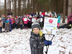 Bruce Bell/The Intelligencer
Brandon Zechel, a Kindergarten student at Stirling Public School, displays one of the handful of signs students made asking residents to clean up after their dogs. The project came after students were becoming frustrated by the amount of dog droppings found in the woods near the school.