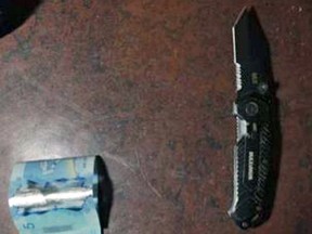 The knife and cash seized after a robbery in Kingston, Ont. on Thursday March 9, 2017. Supplied by Kingston Police