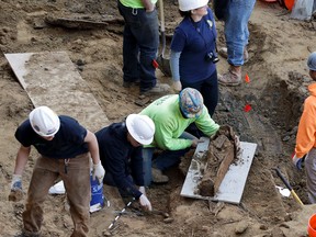 Workers excavate a coffin from a construction site in the Old City neighborhood, Thursday, March 9, 2017, in Philadelphia. (AP Photo/Matt Slocum)