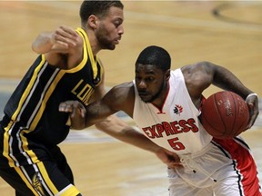 London's Garrett Williamson, left, battles Tony Bennett (5) of the Windsor Express in NBL Canada playoff action at the WFCU Centre on May 19, 2016. (Postmedia Network file photo)