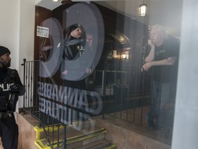 Police inside the Cannabis Culture store on Church Street. Police raid cannabis stores across the country on Thursday March 9, 2017. (Craig Robertson /Toronto Sun)